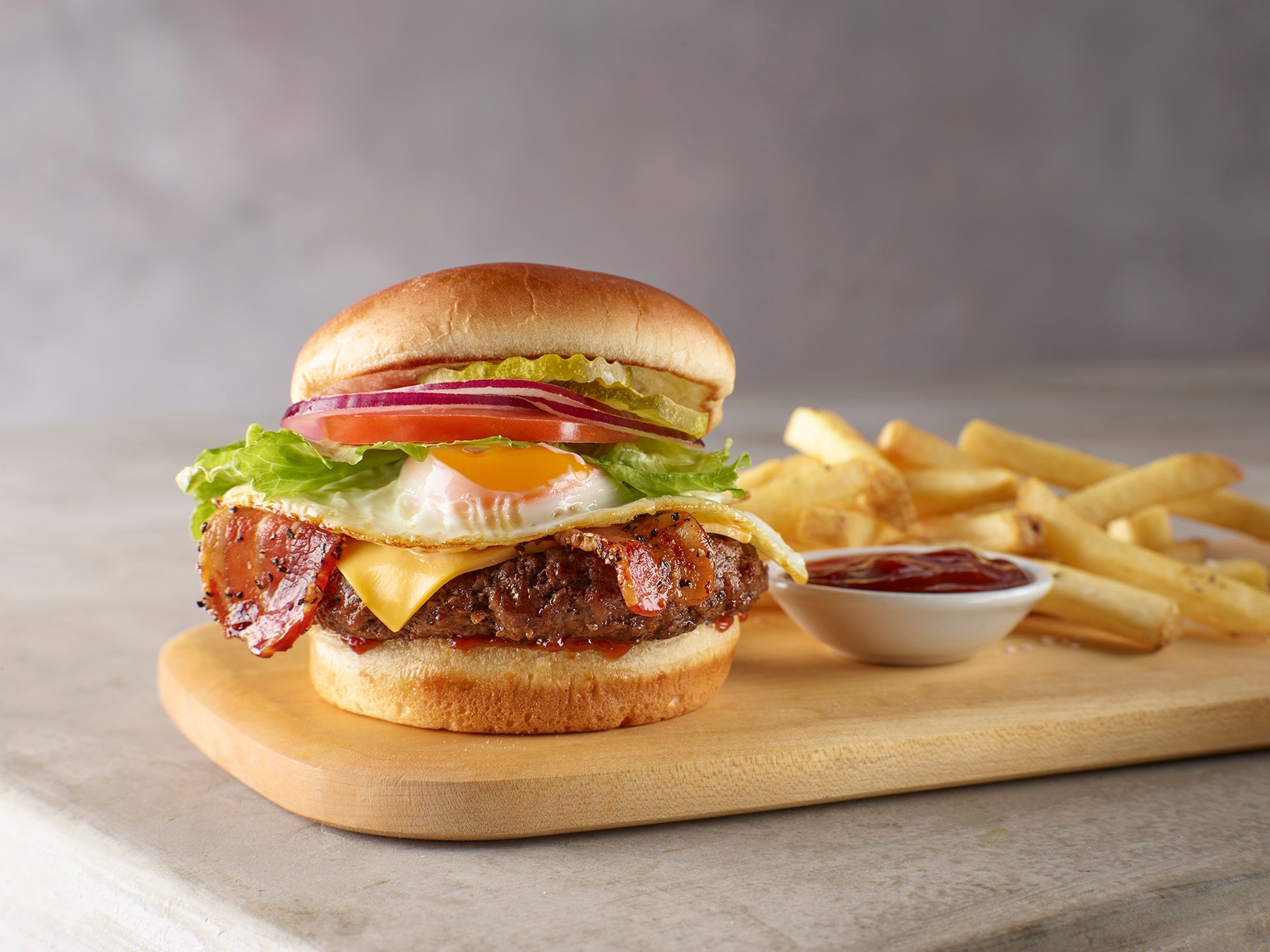 A juicy beef patty topped with chipotle ketchup, American cheese, bacon, and a fried egg. The ultimate brunch burger.